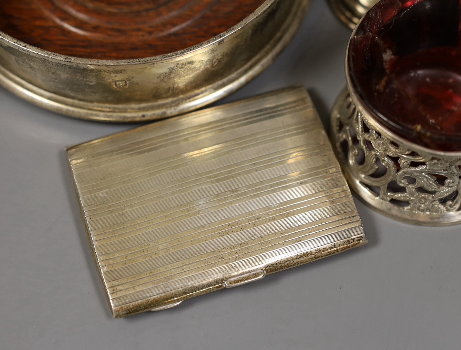 Sundry small silver including a modern wine coaster, a pair of Irish pierced silver salts(a.f.), two goblets, two small trophy cups and a cigarette case.